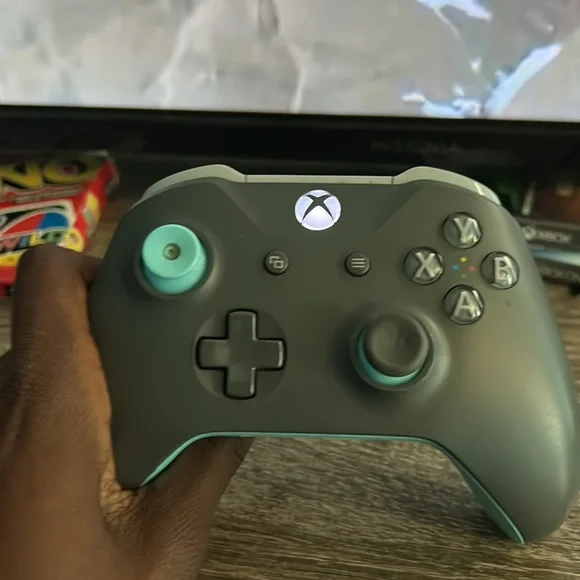 Xbox one console and cyan and grey controller